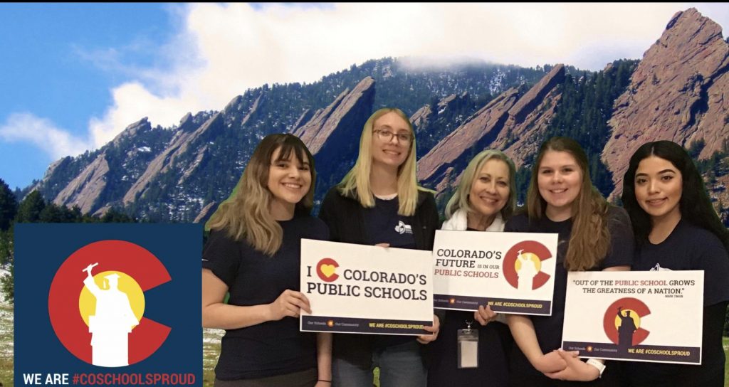P-TEACH students holding #coschoolsproud signs