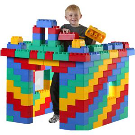 Boy playing with giant building blocks