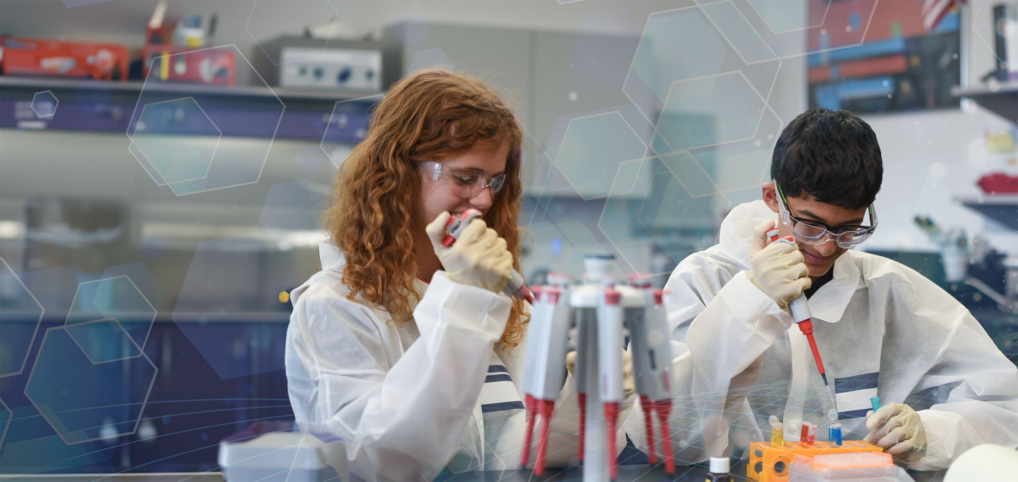 a male and female student work on pipetting in Bioscience coursework at the Innovation Center