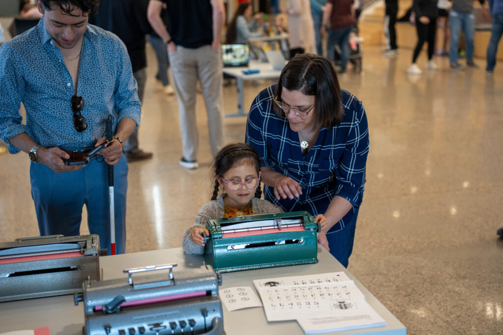 Elementary female student exploring accessibility activity at the Innovation Center.